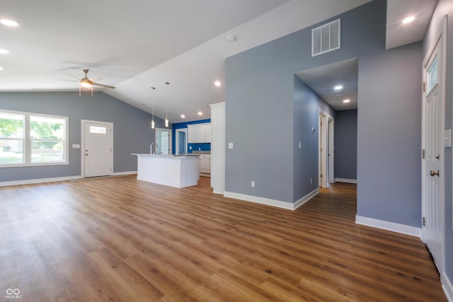5122 W Legrande Ave, Indianapolis, IN 46241 - unfurnished living room with a ceiling fan, wood finished floors, lofted ceiling, and recessed lighting