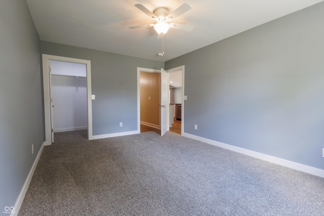 5122 W Legrande Ave, Indianapolis, IN 46241 - unfurnished bedroom with carpet floors, a walk in closet, a closet, and a ceiling fan