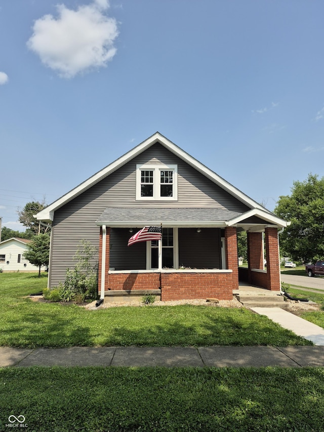 1501 California St, Columbus, IN 47201 - bungalow-style home with a front lawn, a porch, and brick siding