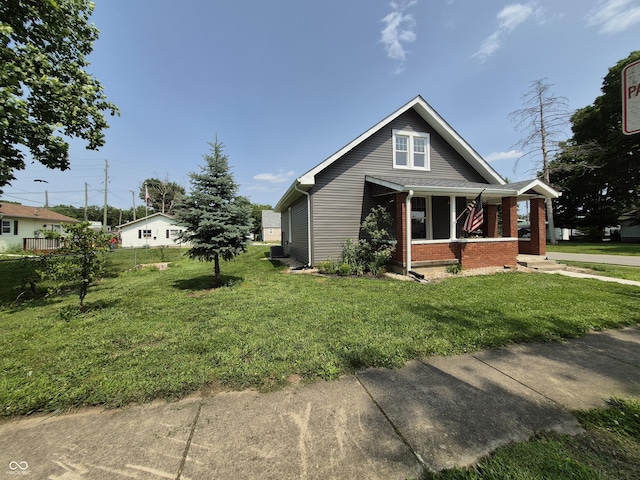 1501 California St, Columbus, IN 47201 - view of home's exterior featuring covered porch, a lawn, and brick siding