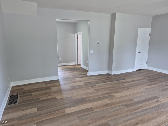 1501 California St, Columbus, IN 47201 - empty room with wood finished floors and baseboards