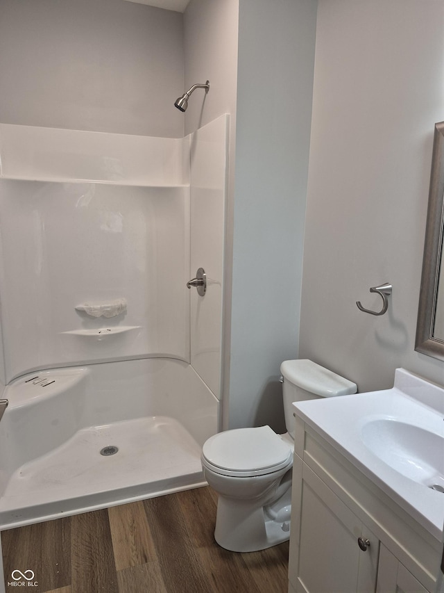 1501 California St, Columbus, IN 47201 - bathroom featuring wood finished floors, vanity, and walk in shower