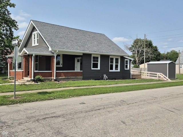 1501 California St, Columbus, IN 47201 - view of front of property with a shingled roof, a storage shed, brick siding, a porch, and crawl space