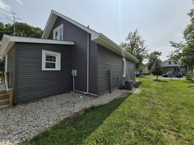 1501 California St, Columbus, IN 47201 - view of side of home with a yard and a central AC unit
