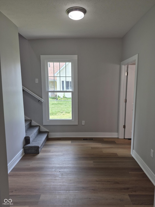 1501 California St, Columbus, IN 47201 - unfurnished living room with stairway and wood finished floors