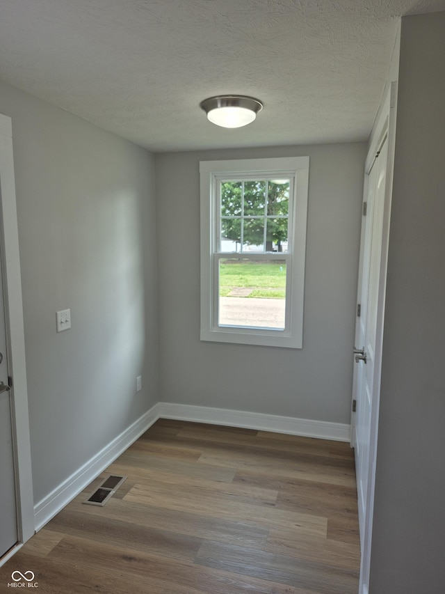 1501 California St, Columbus, IN 47201 - unfurnished room with wood finished floors and a textured ceiling
