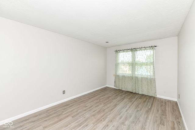 1124 Paradise Ct Unit B, Greenwood, IN 46143 - unfurnished room featuring light wood-type flooring and a textured ceiling