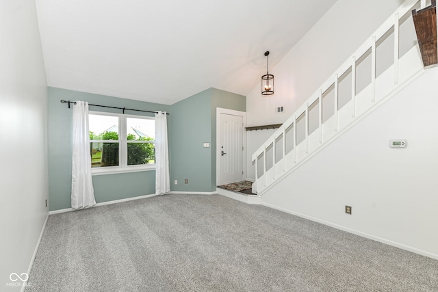 1124 Paradise Ct Unit B, Greenwood, IN 46143 - unfurnished living room with vaulted ceiling, carpet flooring, and stairs