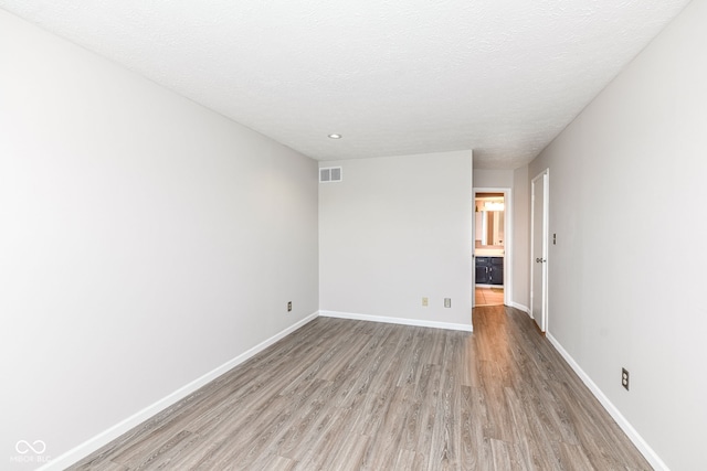 1124 Paradise Ct Unit B, Greenwood, IN 46143 - empty room featuring light wood-type flooring, recessed lighting, and a textured ceiling