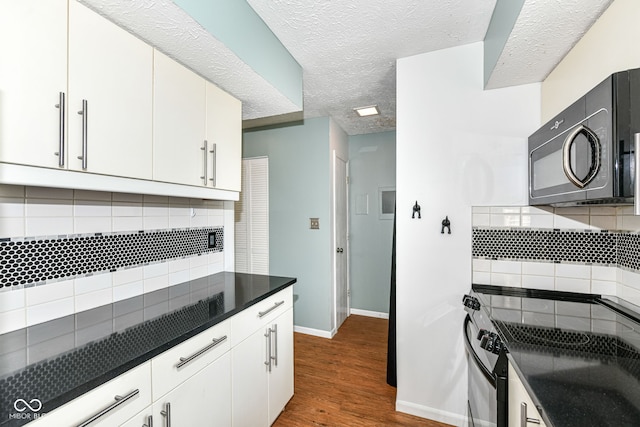 1124 Paradise Ct Unit B, Greenwood, IN 46143 - kitchen with black appliances, decorative backsplash, dark countertops, white cabinets, and a textured ceiling