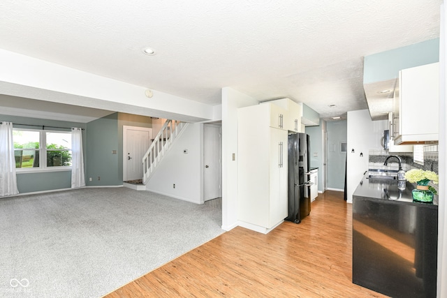 1124 Paradise Ct Unit B, Greenwood, IN 46143 - kitchen featuring freestanding refrigerator, white cabinetry, light wood-type flooring, recessed lighting, and a textured ceiling
