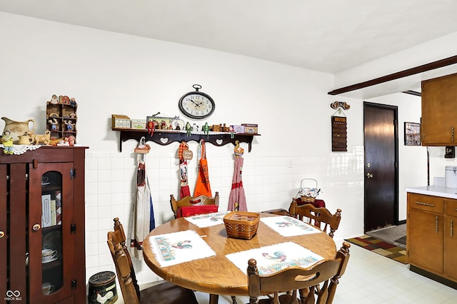11630 Deanna Dr, Indianapolis, IN 46229 - dining area with tile walls, light flooring, and a wainscoted wall
