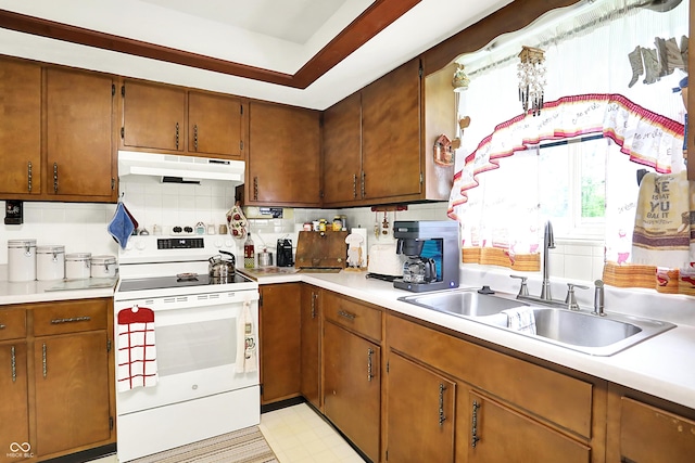 11630 Deanna Dr, Indianapolis, IN 46229 - kitchen with white electric range oven, under cabinet range hood, light countertops, brown cabinetry, and light flooring