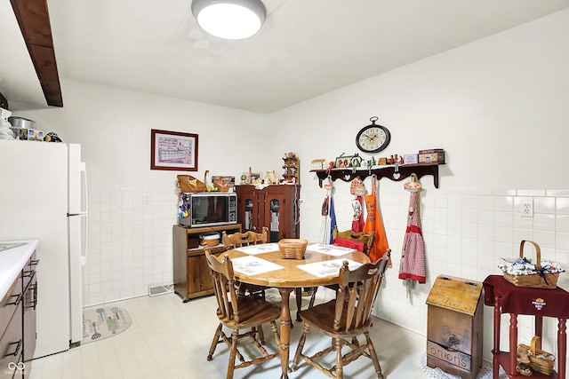 11630 Deanna Dr, Indianapolis, IN 46229 - dining room with tile walls, wainscoting, and light tile patterned flooring