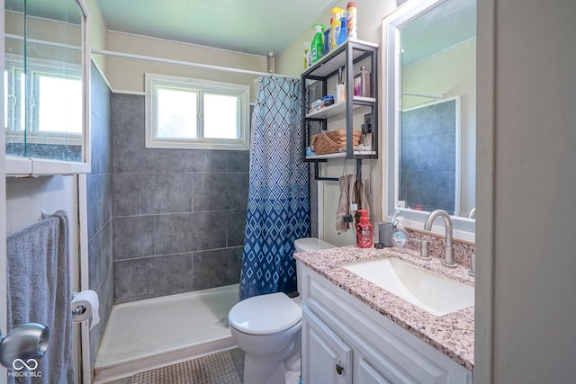 11 Sayre Dr, Greenwood, IN 46143 - bathroom featuring vanity, tiled shower, and tile patterned floors