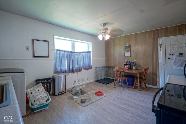 11 Sayre Dr, Greenwood, IN 46143 - dining space with a ceiling fan, wood finished floors, wooden walls, and washer / dryer