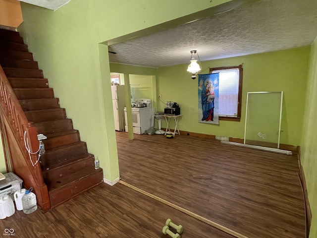 1163 Groff Ave, Indianapolis, IN 46222 - unfurnished living room featuring wood finished floors, a textured ceiling, and stairway
