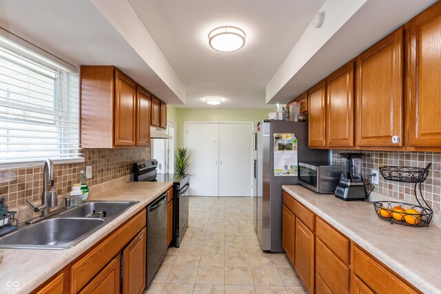 2170 N Old State Road 9, Columbus, IN 47203 - kitchen featuring appliances with stainless steel finishes, backsplash, brown cabinetry, and light countertops
