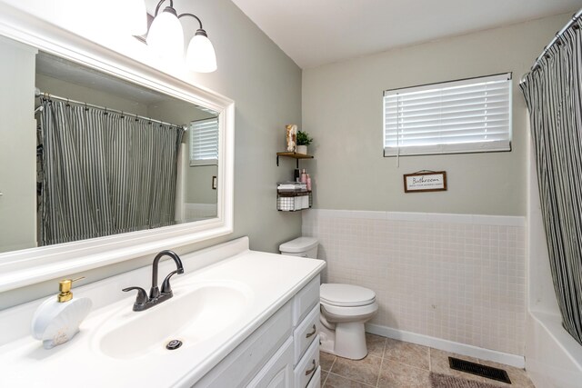 2170 N Old State Road 9, Columbus, IN 47203 - bathroom featuring vanity, tile patterned floors, tile walls, a shower with curtain, and wainscoting