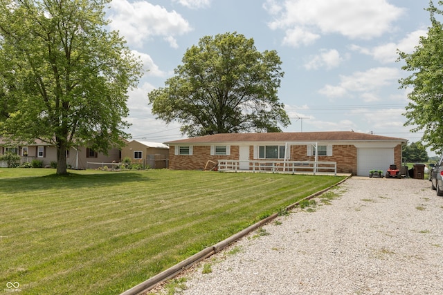 2170 N Old State Road 9, Columbus, IN 47203 - view of front of home featuring driveway, a garage, a front lawn, and brick siding
