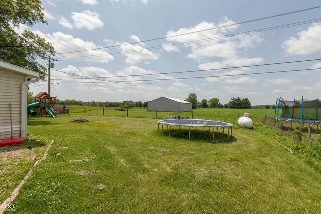 2170 N Old State Road 9, Columbus, IN 47203 - view of grassy yard featuring a trampoline, a playground, a view of countryside, and an outdoor structure