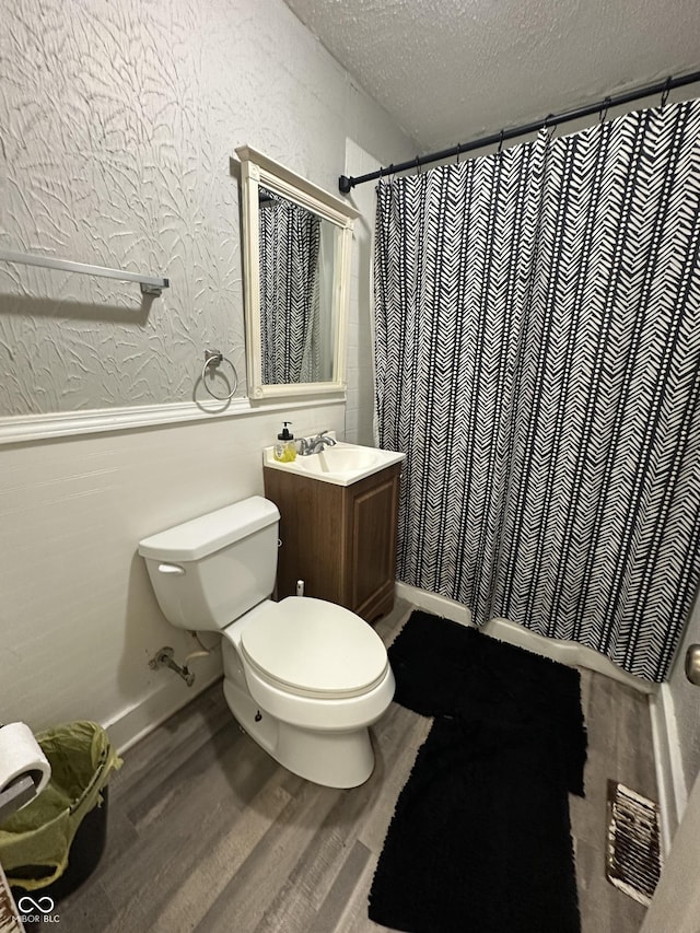 4744 E 33rd St, Indianapolis, IN 46218 - bathroom with a textured ceiling, wood finished floors, wainscoting, vanity, and a shower with shower curtain