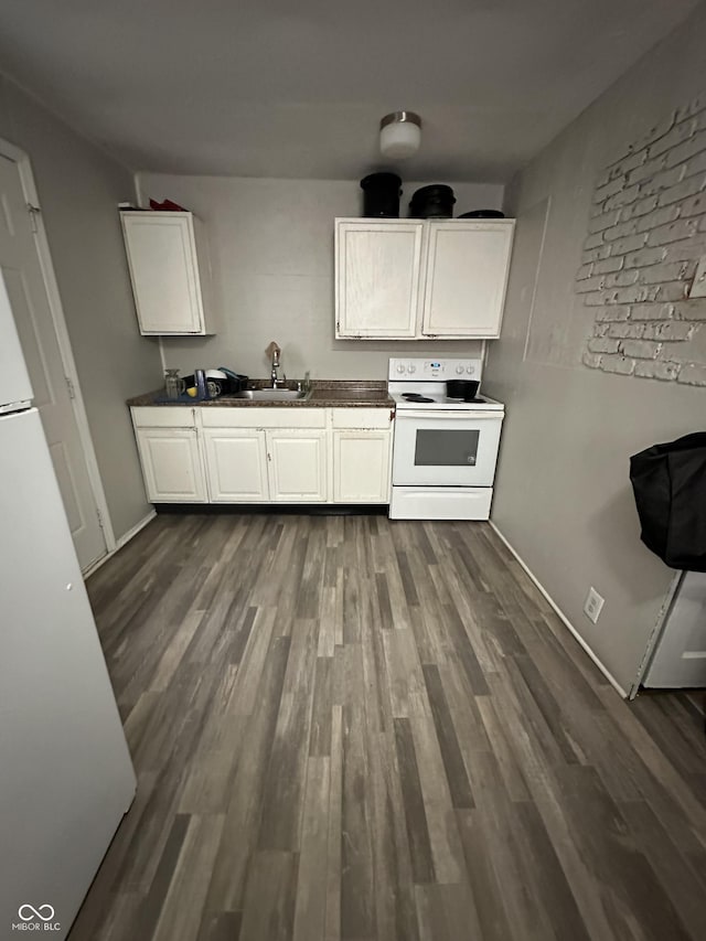 4744 E 33rd St, Indianapolis, IN 46218 - kitchen with white range with electric stovetop, dark wood finished floors, dark countertops, and white cabinetry