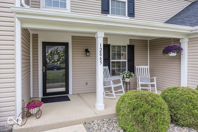 12845 Touchdown Dr, Fishers, IN 46037 - doorway to property with covered porch and a shingled roof