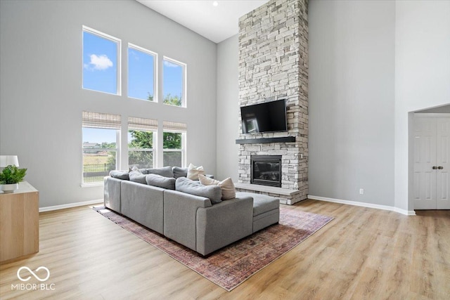4253 Ironclad Dr, Bargersville, IN 46106 - living area featuring a high ceiling, light wood-style floors, and a stone fireplace