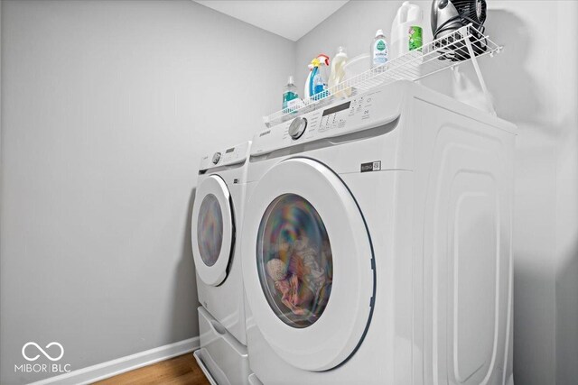 4253 Ironclad Dr, Bargersville, IN 46106 - laundry room featuring washer and clothes dryer and wood finished floors