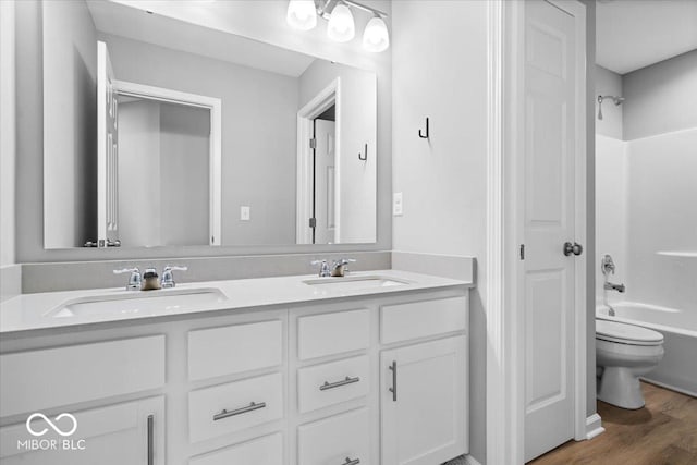 4253 Ironclad Dr, Bargersville, IN 46106 - bathroom with double vanity, washtub / shower combination, and wood finished floors