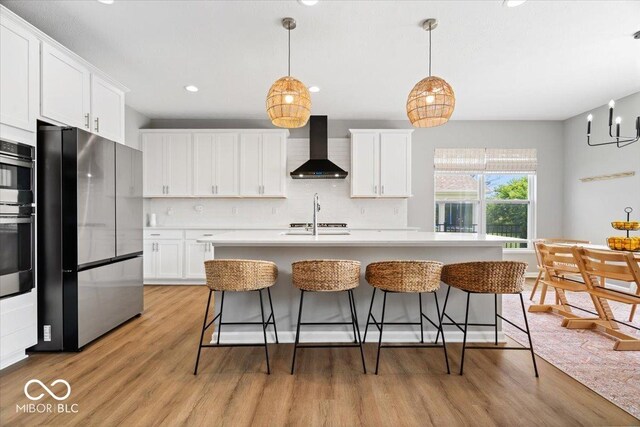 4253 Ironclad Dr, Bargersville, IN 46106 - kitchen featuring wall chimney range hood, freestanding refrigerator, decorative backsplash, white cabinets, and recessed lighting