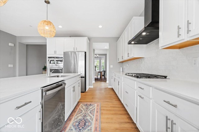 4253 Ironclad Dr, Bargersville, IN 46106 - kitchen featuring wall chimney exhaust hood, appliances with stainless steel finishes, white cabinetry, light countertops, and backsplash