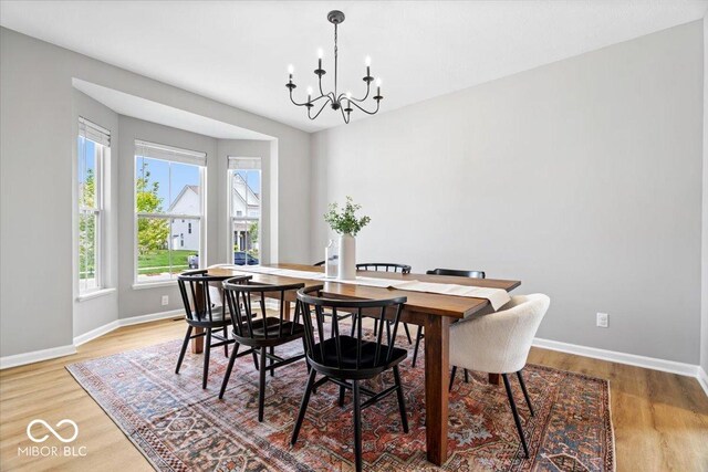 4253 Ironclad Dr, Bargersville, IN 46106 - dining space featuring a chandelier and light wood finished floors