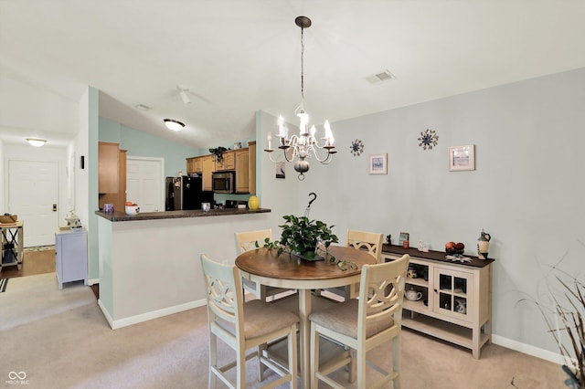 5011 Amber Creek Pl Unit 310, Indianapolis, IN 46237 - dining area featuring light carpet, a chandelier, and vaulted ceiling