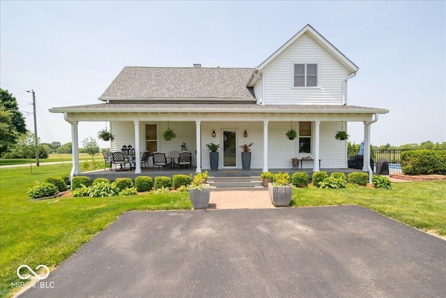 7728 W 200 S, New Palestine, IN 46163 - farmhouse featuring a porch, a front yard, and roof with shingles