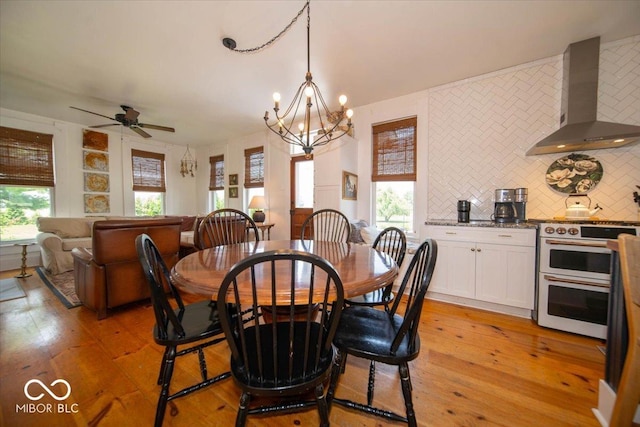 7728 W 200 S, New Palestine, IN 46163 - dining space featuring light wood-style flooring, a chandelier, and a ceiling fan