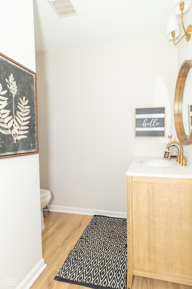 8429 Catamaran Dr, Indianapolis, IN 46236 - bathroom featuring wood finished floors, vanity, and a chandelier