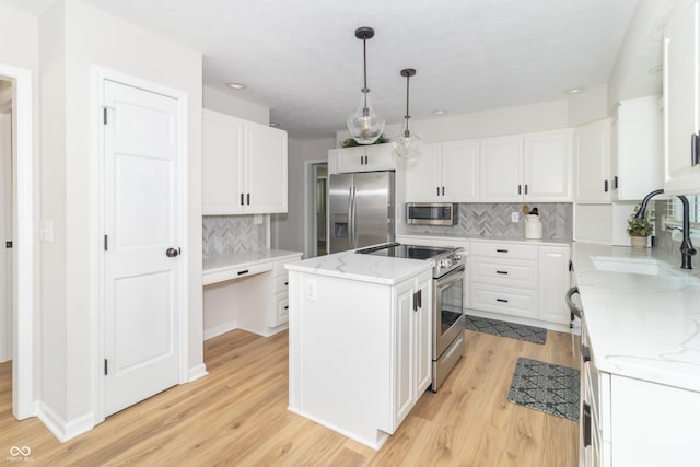8429 Catamaran Dr, Indianapolis, IN 46236 - kitchen with appliances with stainless steel finishes, a center island, tasteful backsplash, and light wood-style floors