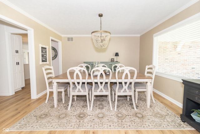 8429 Catamaran Dr, Indianapolis, IN 46236 - dining room featuring a chandelier, wood finished floors, and crown molding