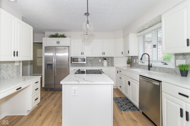 8429 Catamaran Dr, Indianapolis, IN 46236 - kitchen with appliances with stainless steel finishes, tasteful backsplash, a center island, white cabinets, and light stone counters