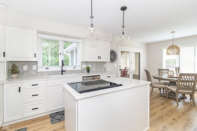 8429 Catamaran Dr, Indianapolis, IN 46236 - kitchen featuring light wood-style floors, tasteful backsplash, a center island, and white cabinetry