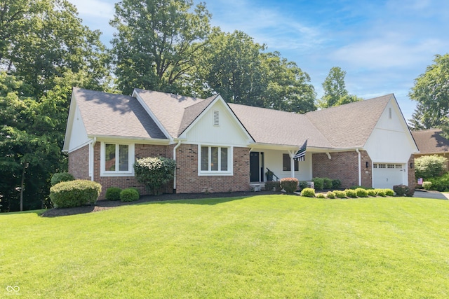 8429 Catamaran Dr, Indianapolis, IN 46236 - view of front of home featuring a front lawn, an attached garage, brick siding, and roof with shingles