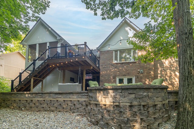 8429 Catamaran Dr, Indianapolis, IN 46236 - back of house featuring stairway, a wooden deck, brick siding, and a sunroom
