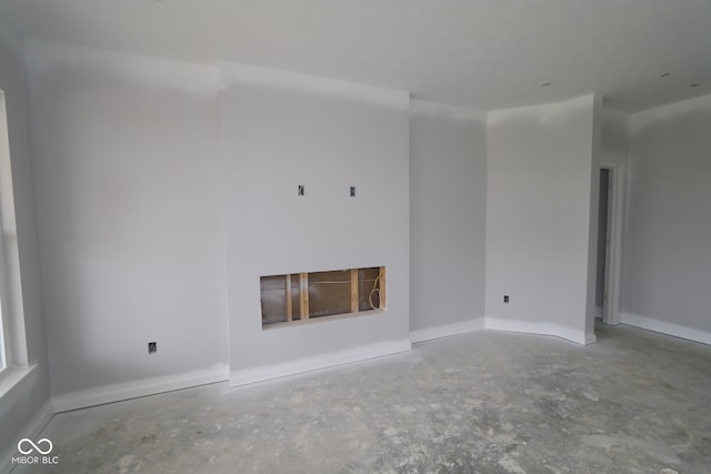 12524 Morning Ridge Way, Noblesville, IN 46060 - unfurnished living room with unfinished concrete flooring and a fireplace