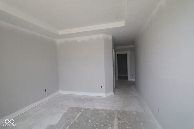 12524 Morning Ridge Way, Noblesville, IN 46060 - empty room with unfinished concrete flooring and a tray ceiling