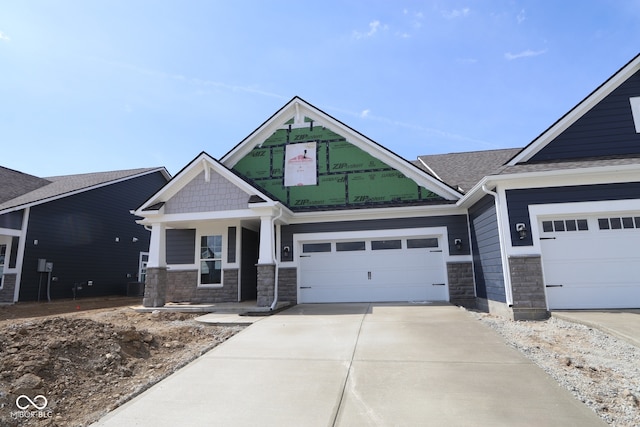 12524 Morning Ridge Way, Noblesville, IN 46060 - craftsman-style house with stone siding, driveway, a garage, and covered porch