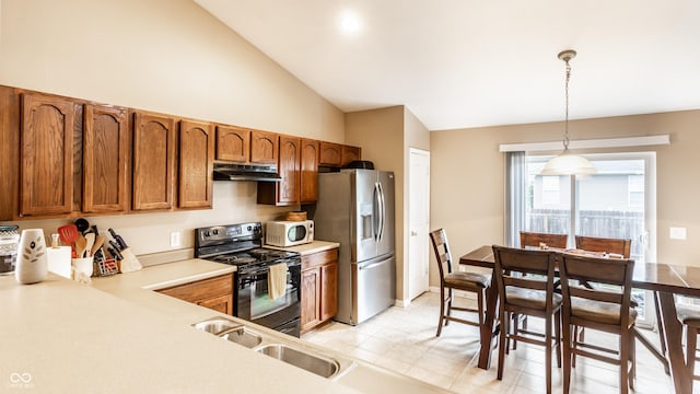 8116 Harshaw Dr, Indianapolis, IN 46239 - kitchen featuring electric range, under cabinet range hood, white microwave, stainless steel fridge with ice dispenser, and brown cabinetry