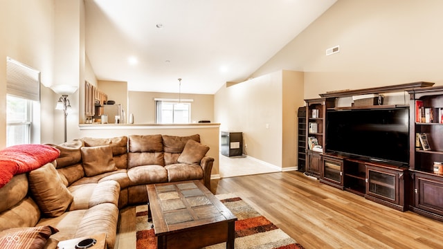 8116 Harshaw Dr, Indianapolis, IN 46239 - living room featuring high vaulted ceiling and light wood-type flooring