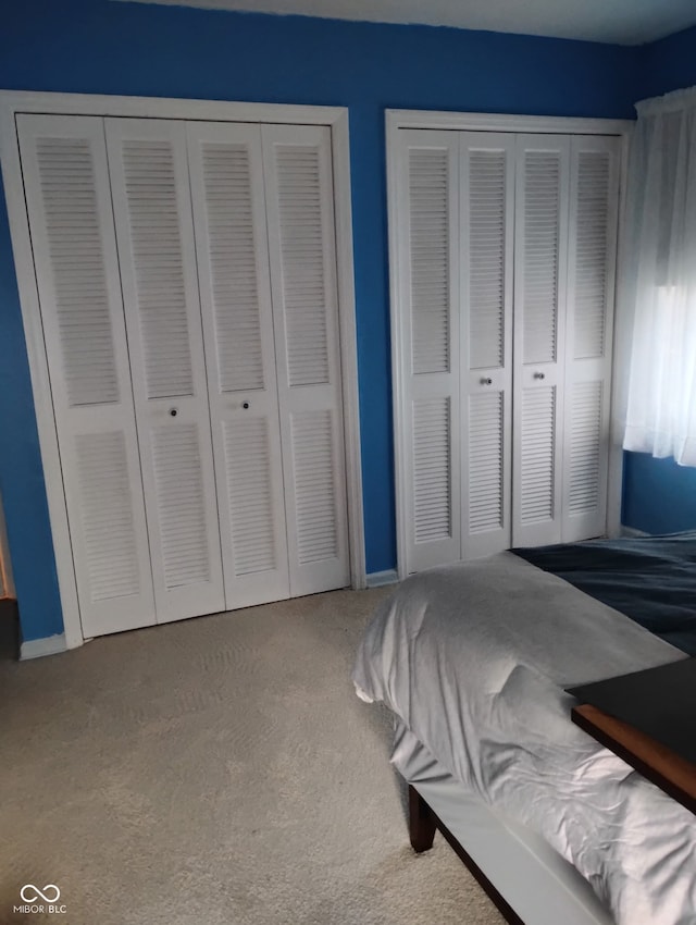 721 Maplewood Ave, Anderson, IN 46012 - carpeted bedroom featuring two closets and baseboards